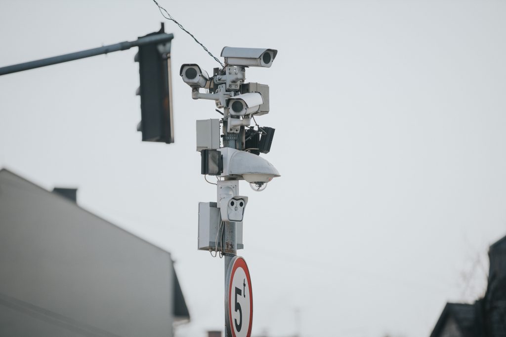 A shallow focus shot of multi-angle traffic cameras on the street pole
